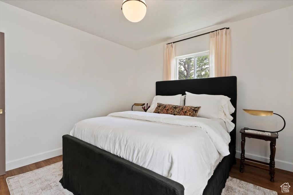 Bedroom featuring baseboards and wood finished floors