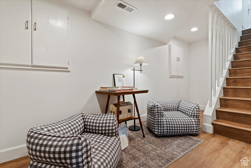 Living area featuring stairway, baseboards, light wood-style floors, and recessed lighting