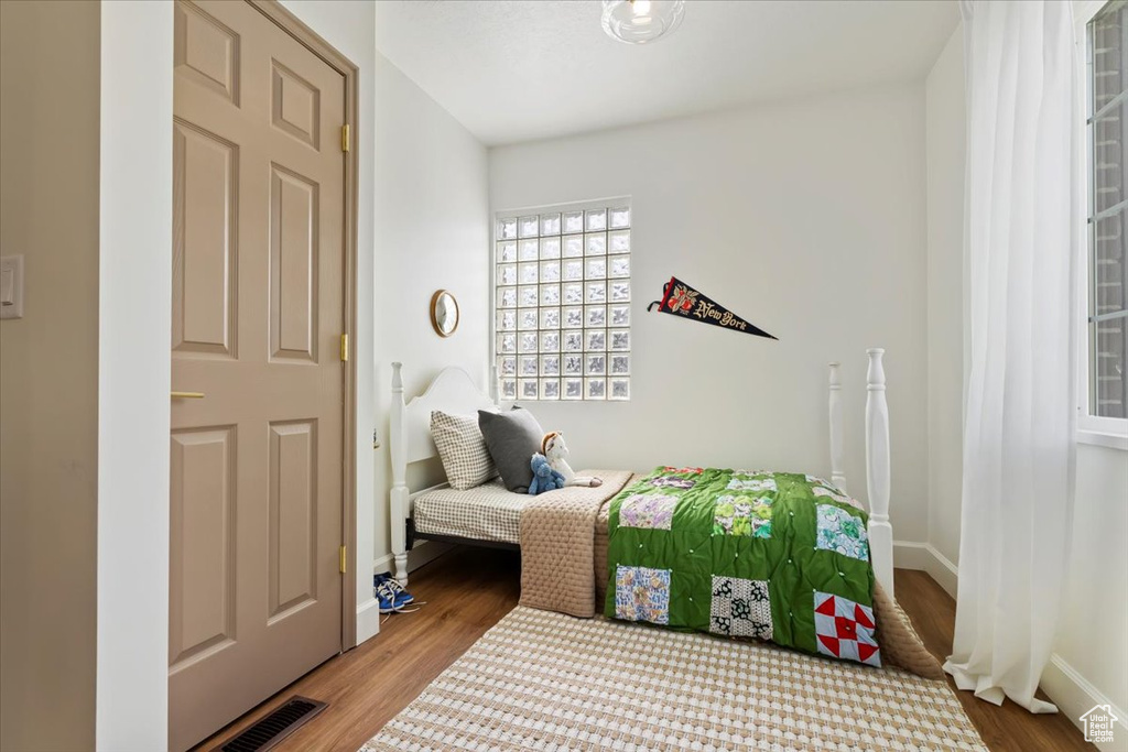 Bedroom featuring wood finished floors and baseboards