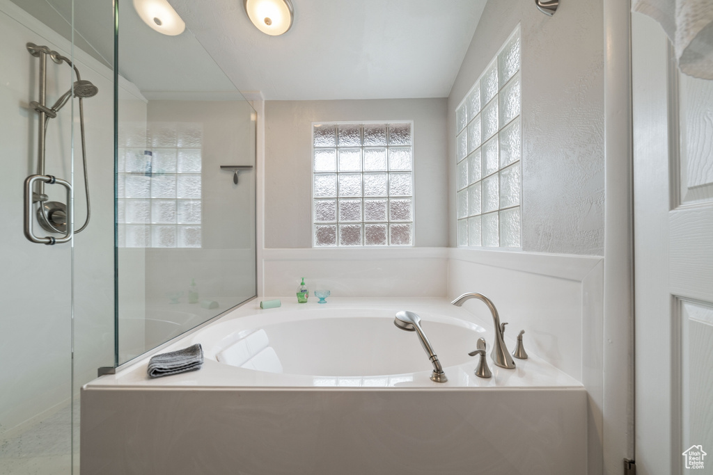 Full bath featuring a shower stall and a bath