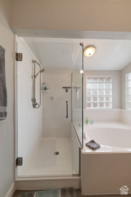 Full bathroom with a garden tub and a shower stall