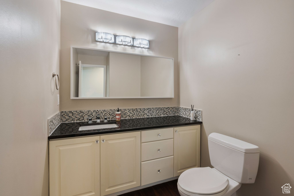 Half bathroom featuring toilet and vanity