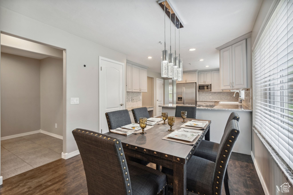 Dining room featuring dark wood-style floors, recessed lighting, and baseboards