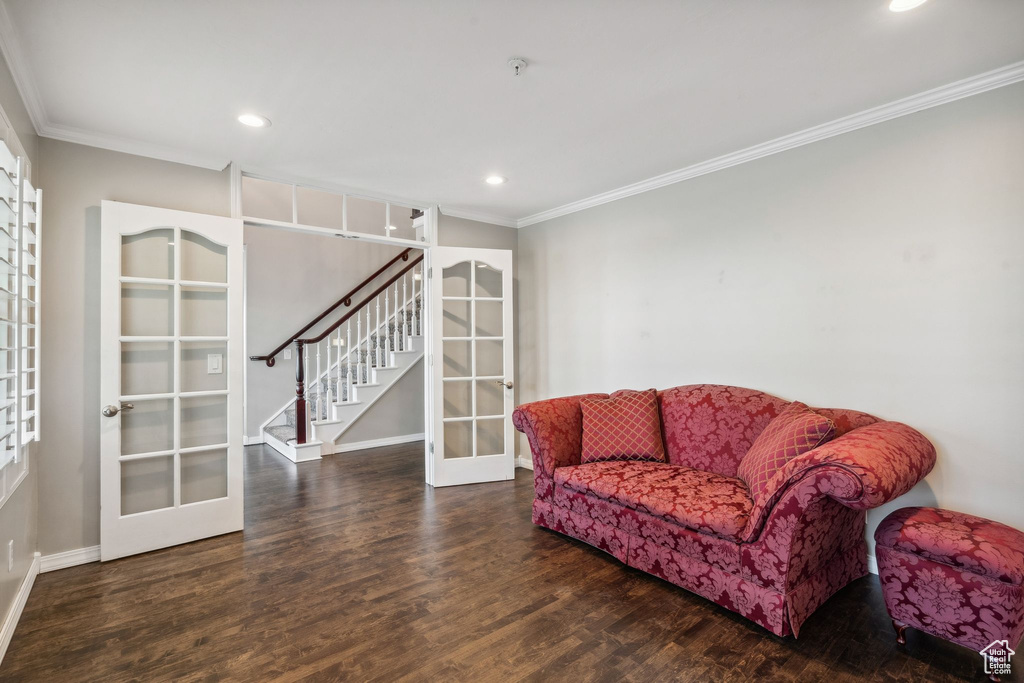 Sitting room featuring french doors, crown molding, wood finished floors, baseboards, and recessed lighting