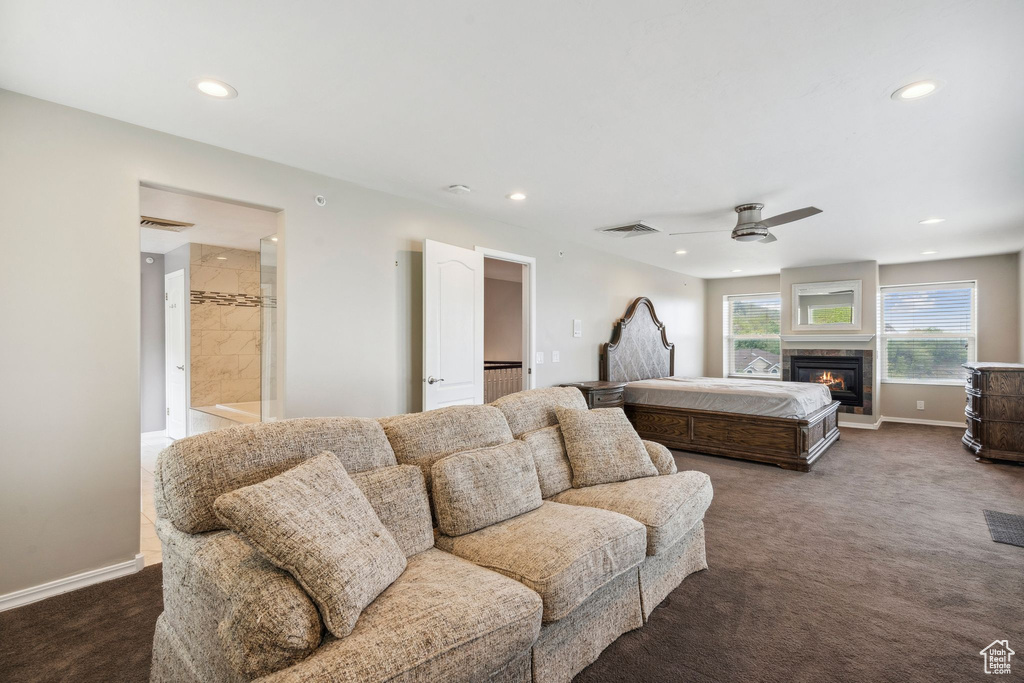 Bedroom featuring carpet, recessed lighting, baseboards, a glass covered fireplace, and a ceiling fan