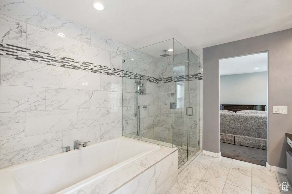 Bathroom featuring a shower stall, a bath, marble finish floors, recessed lighting, and vanity