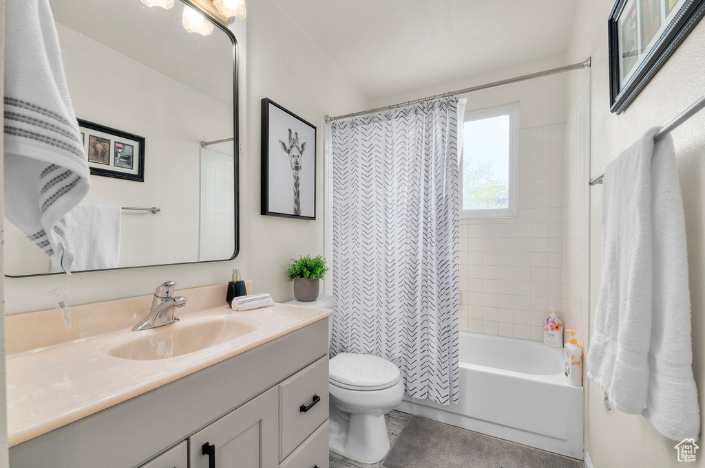 Full bath with toilet, vanity, and shower / tub combo