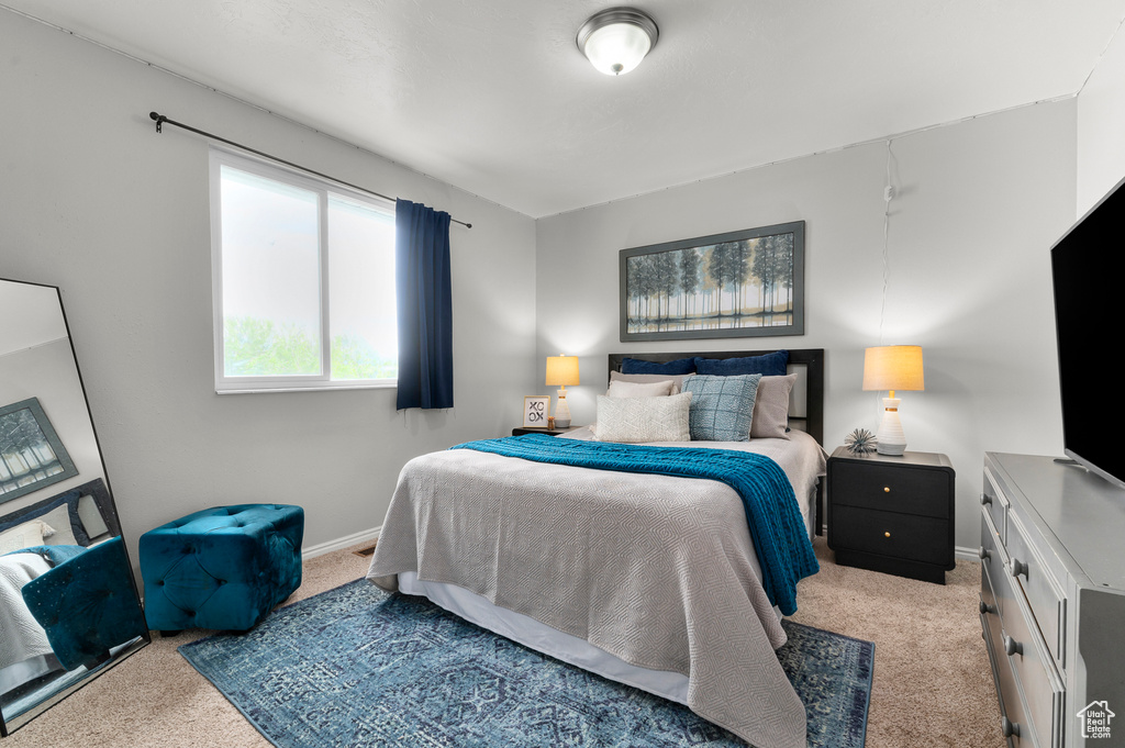 Carpeted bedroom featuring baseboards