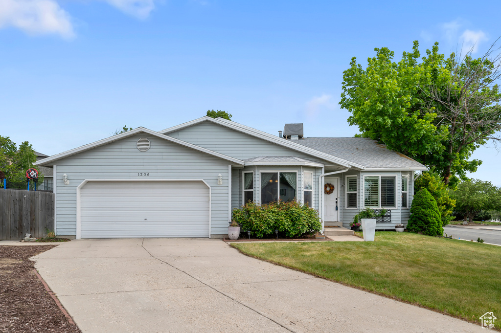 Ranch-style home featuring an attached garage and concrete driveway