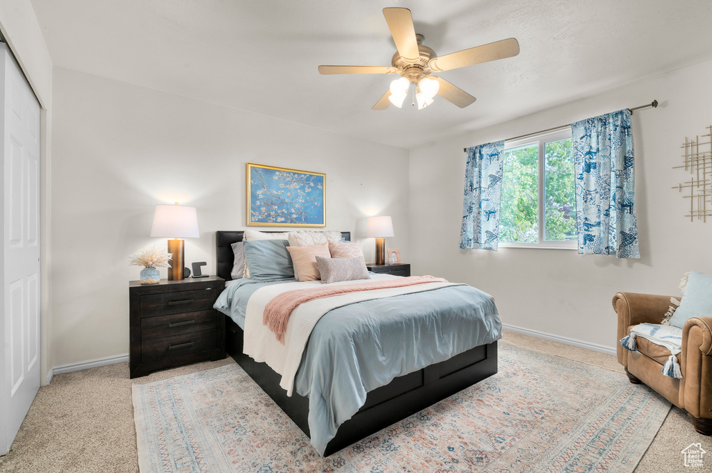 Bedroom featuring carpet flooring, baseboards, and a ceiling fan