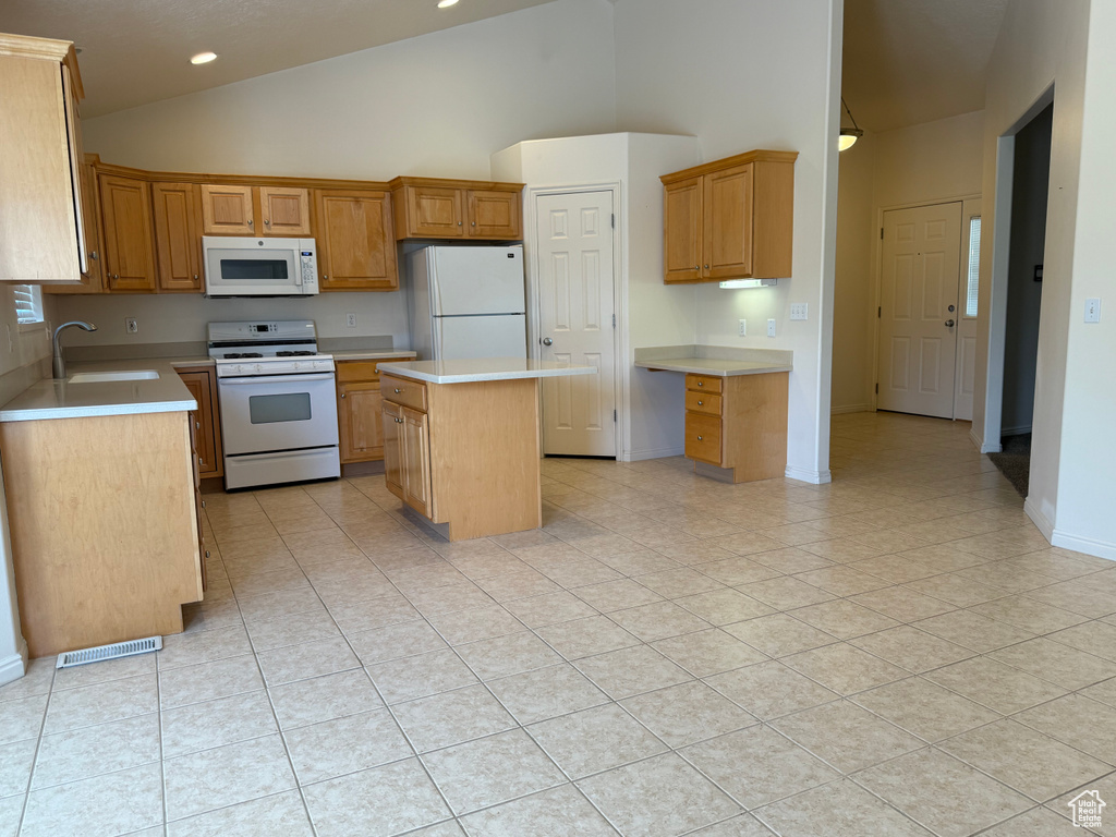 Kitchen with white appliances, high vaulted ceiling, a sink, a center island, and light countertops