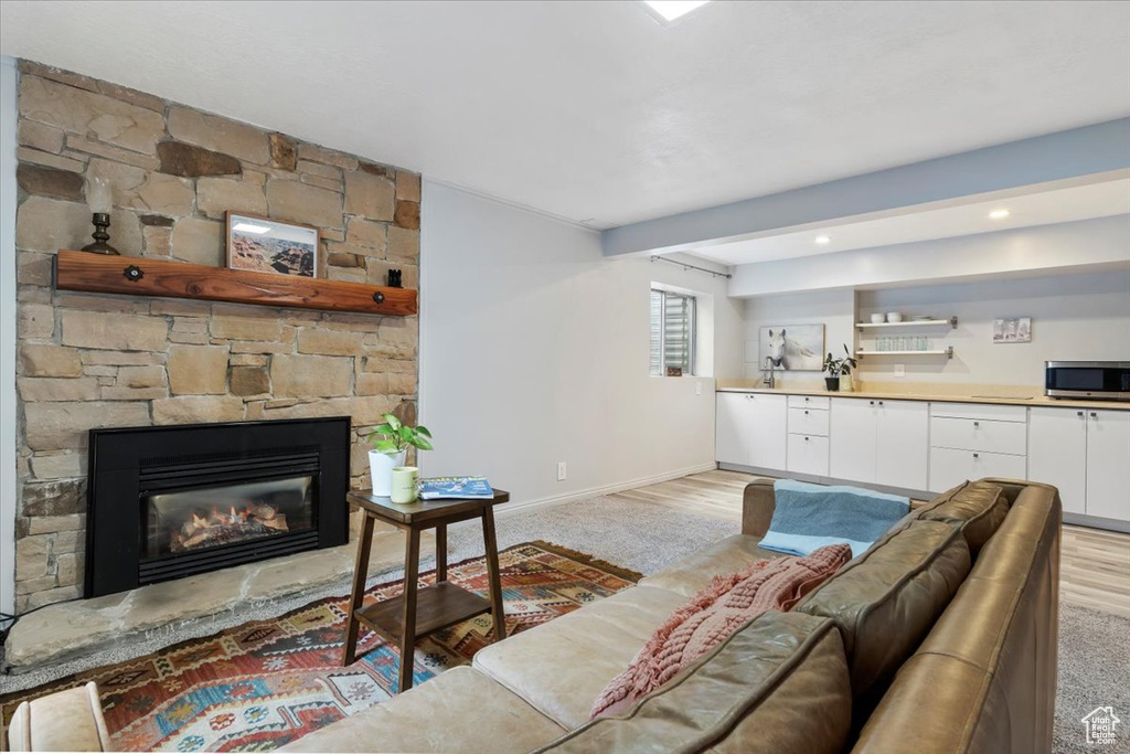 Living room featuring baseboards and a fireplace