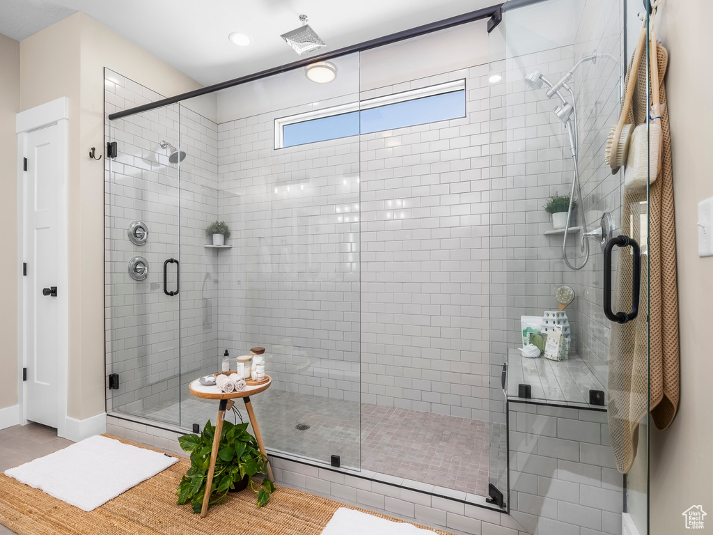 Full bathroom featuring baseboards and a shower stall