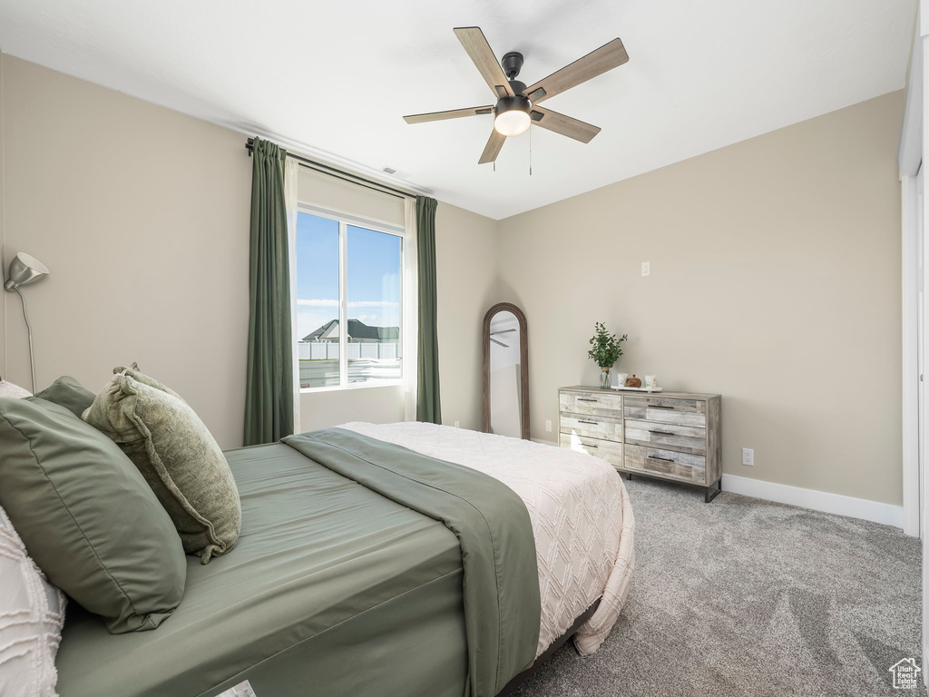 Bedroom with baseboards, a ceiling fan, and carpet flooring
