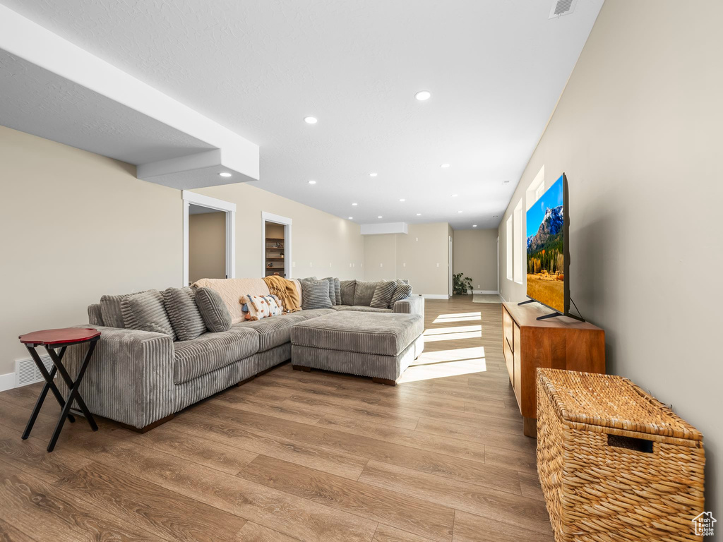 Living area featuring recessed lighting, baseboards, and wood finished floors