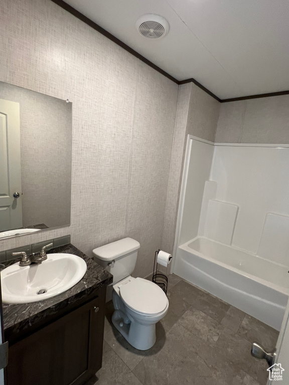 Full bath with shower / bathing tub combination, toilet, vanity, ornamental molding, and visible vents