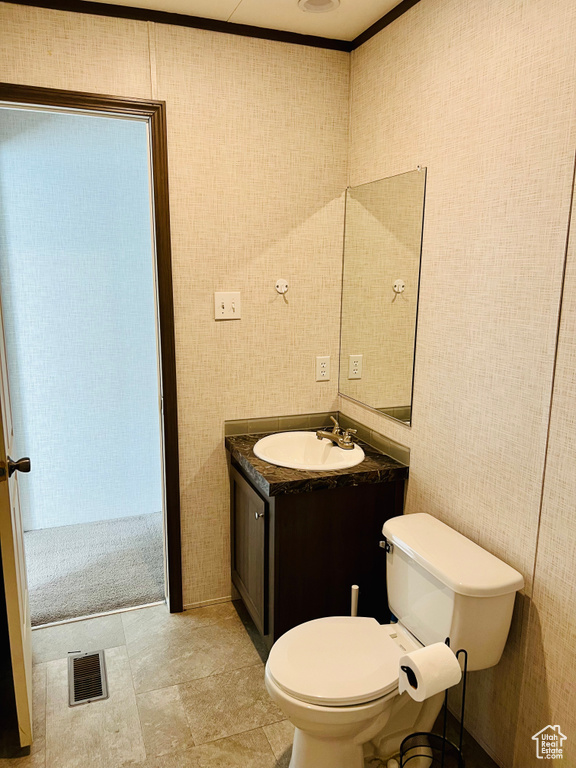 Bathroom with vanity, toilet, tile walls, and visible vents