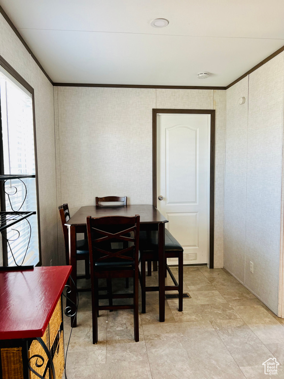 Dining space featuring ornamental molding