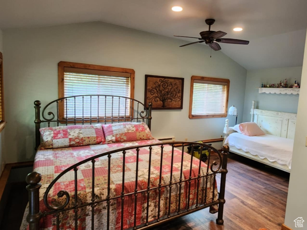 Bedroom featuring vaulted ceiling, wood finished floors, recessed lighting, baseboards, and ceiling fan