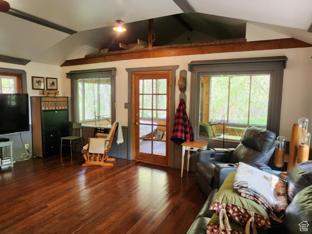 Living area with wood finished floors, plenty of natural light, and a ceiling fan