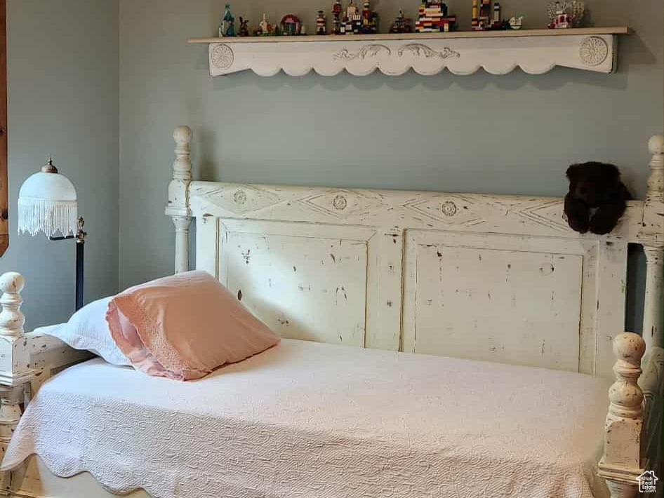 Bedroom with wood finished floors and lofted ceiling