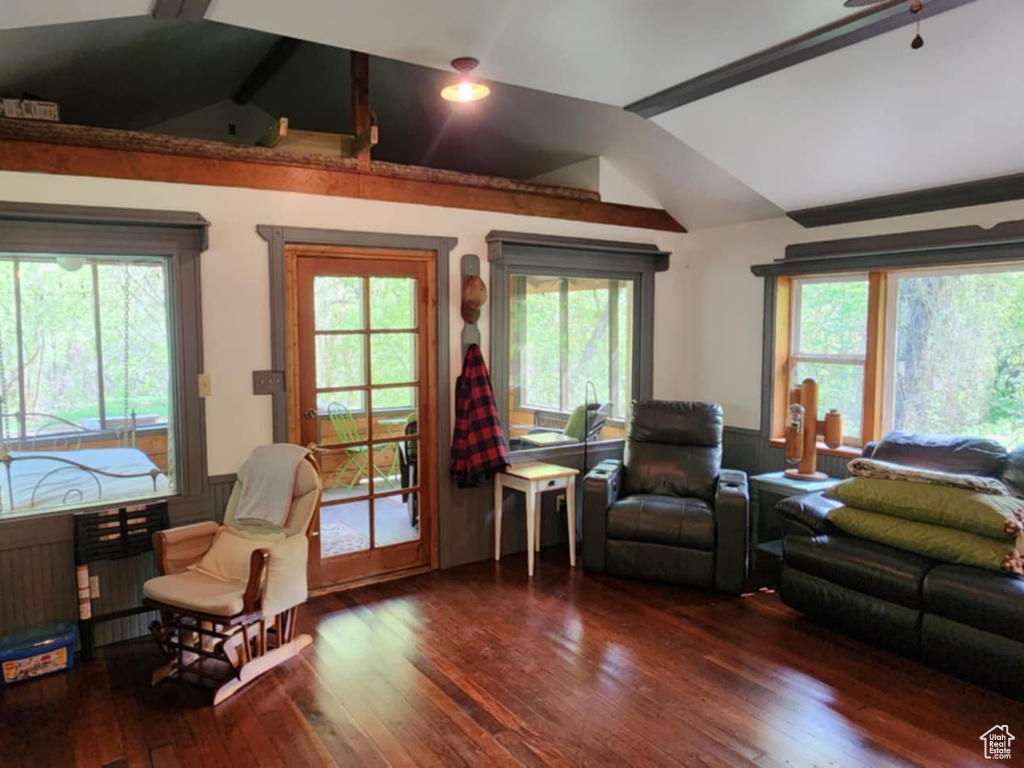 Living area featuring vaulted ceiling and wood finished floors