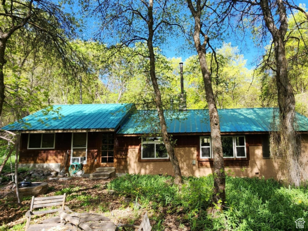 View of front of house with metal roof