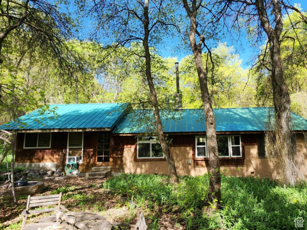 View of front of house with metal roof