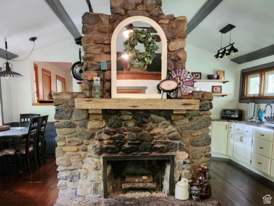 Unfurnished living room featuring ceiling fan, a fireplace, and dark wood-style flooring