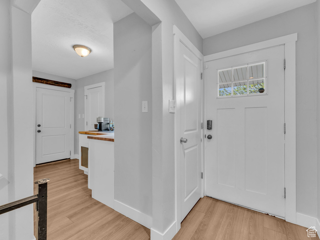 Foyer featuring light wood-type flooring and baseboards