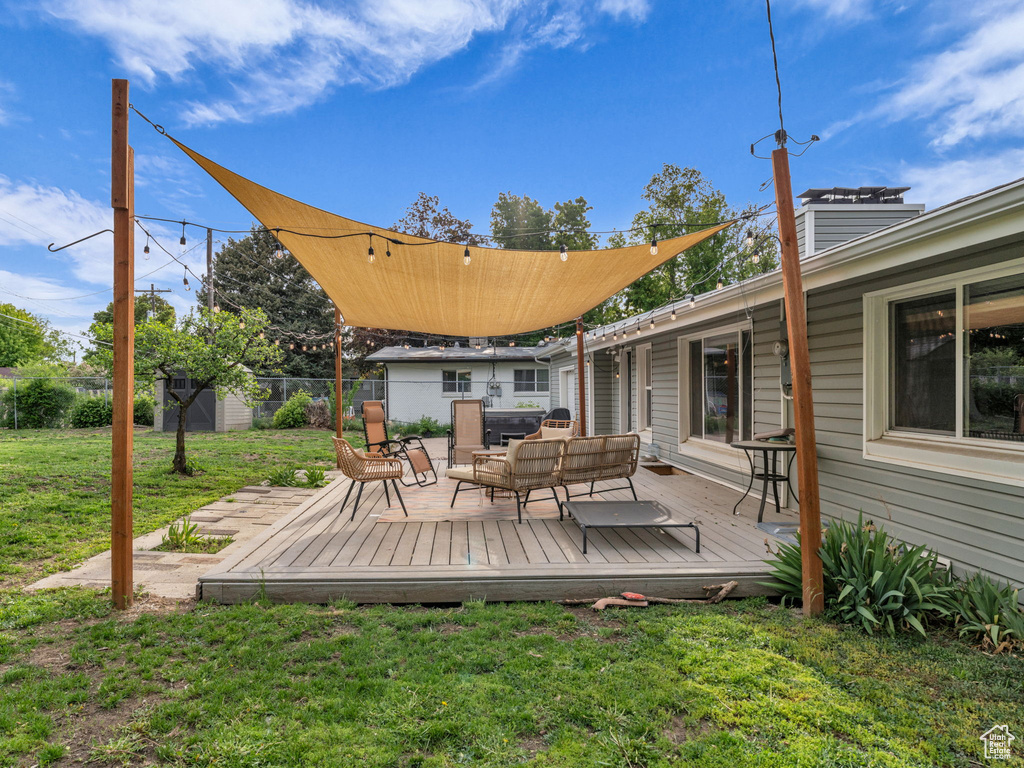 Wooden deck featuring an outdoor living space and an outbuilding