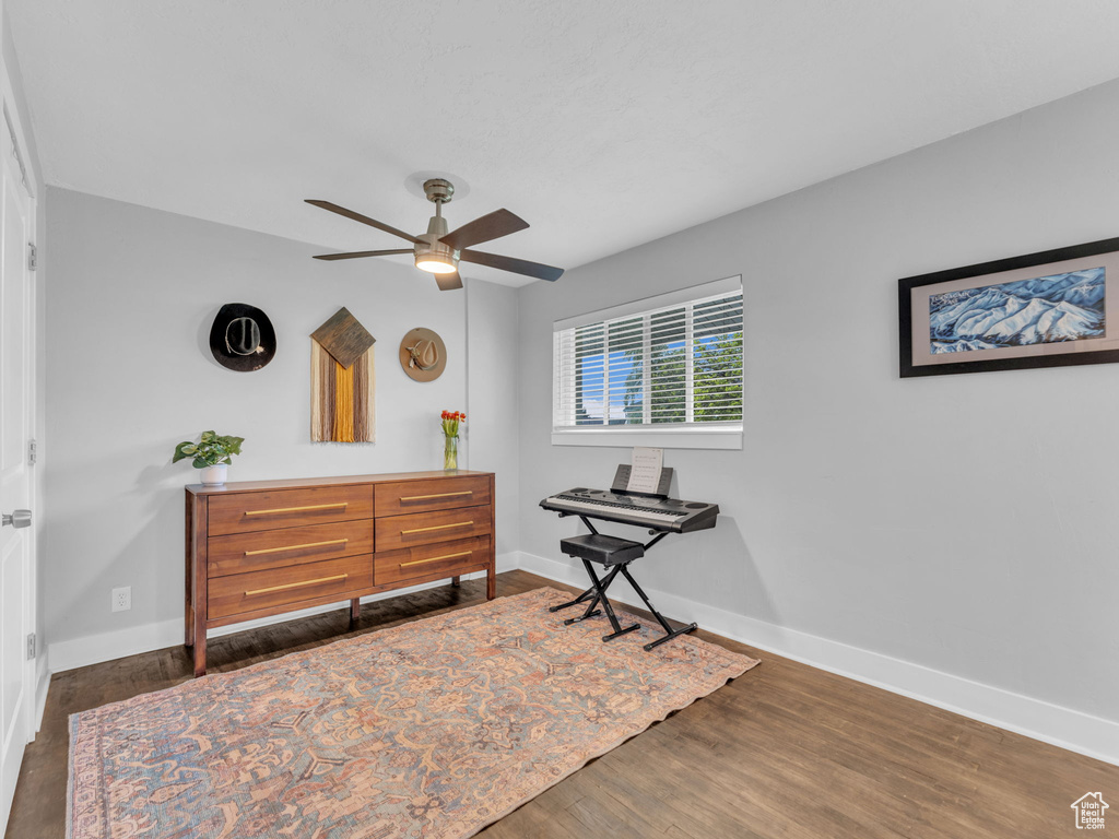 Bedroom featuring baseboards, wood finished floors, and ceiling fan