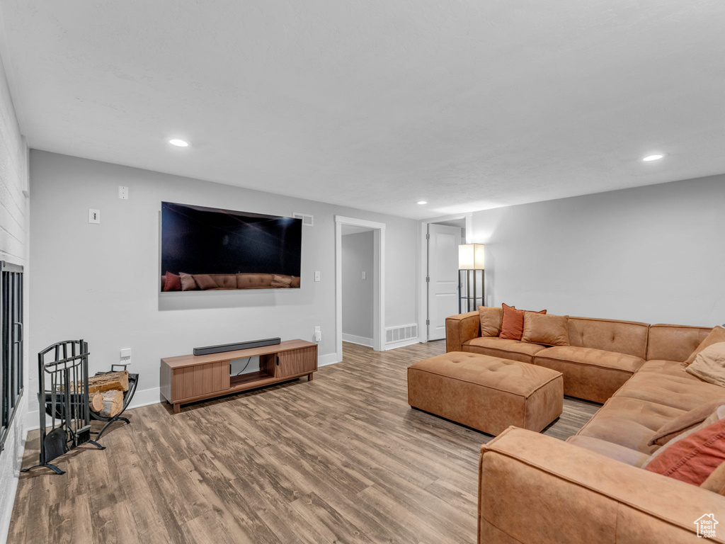 Living area with wood finished floors, recessed lighting, and baseboards