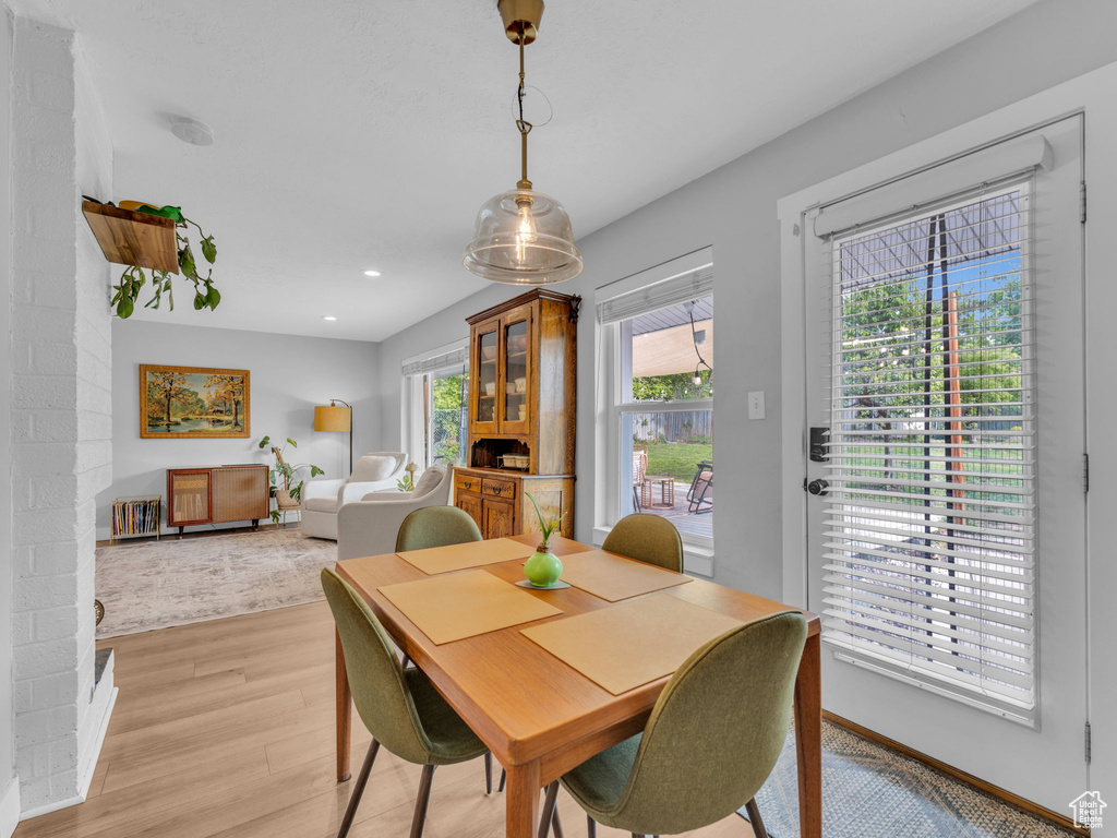 Dining space with light wood finished floors, recessed lighting, and baseboards