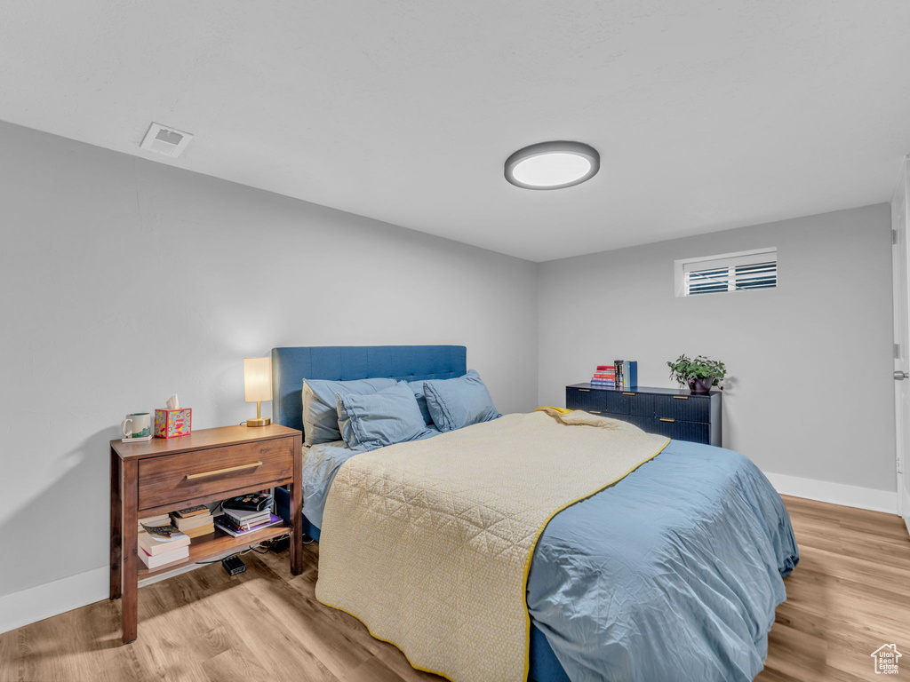 Bedroom featuring wood finished floors and baseboards