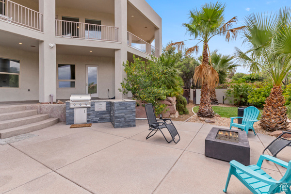 View of patio / terrace with an outdoor fire pit, exterior kitchen, and grilling area