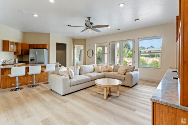 Living area featuring light wood finished floors, recessed lighting, and ceiling fan