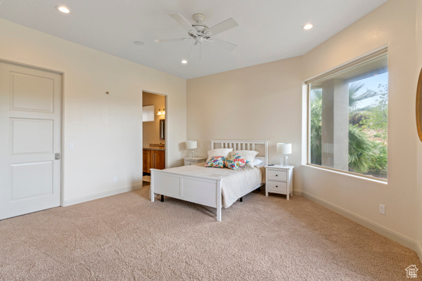 Bedroom featuring carpet flooring, recessed lighting, baseboards, ceiling fan, and ensuite bath