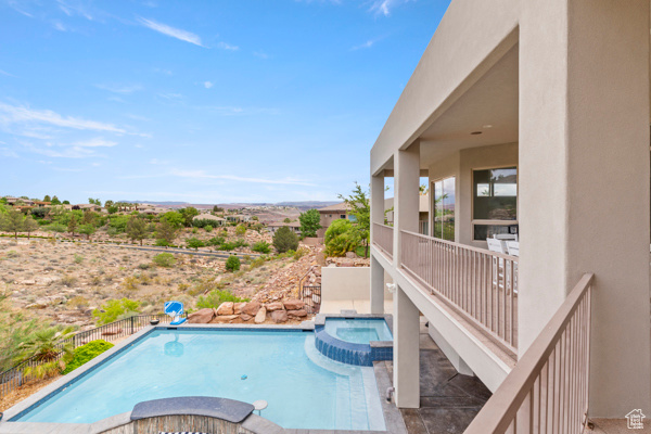 View of swimming pool featuring a pool with connected hot tub