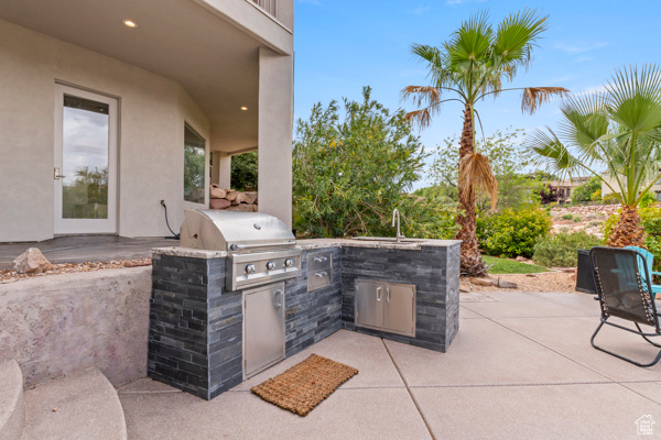 View of patio with grilling area, area for grilling, and a sink