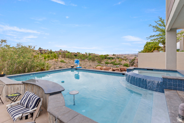 View of swimming pool with a pool with connected hot tub