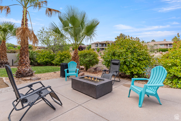 View of patio featuring a fire pit and fence