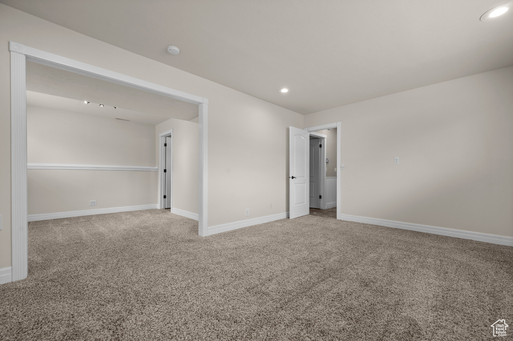 Carpeted empty room with recessed lighting, baseboards, and a smoke detector