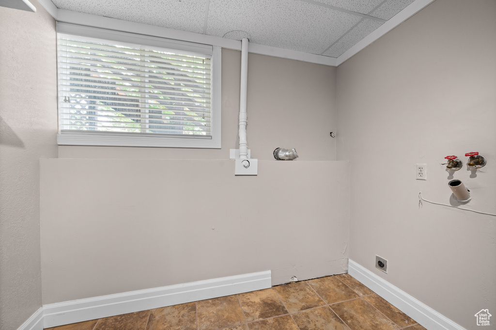 Clothes washing area featuring hookup for an electric dryer, baseboards, and washer hookup