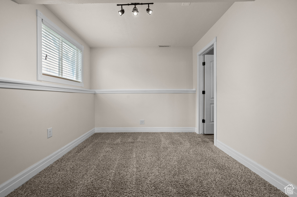 Spare room with carpet and baseboards