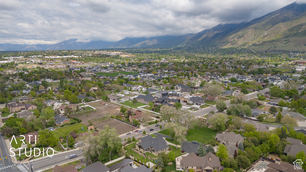Aerial view of property's location featuring a mountainous background and nearby suburban area