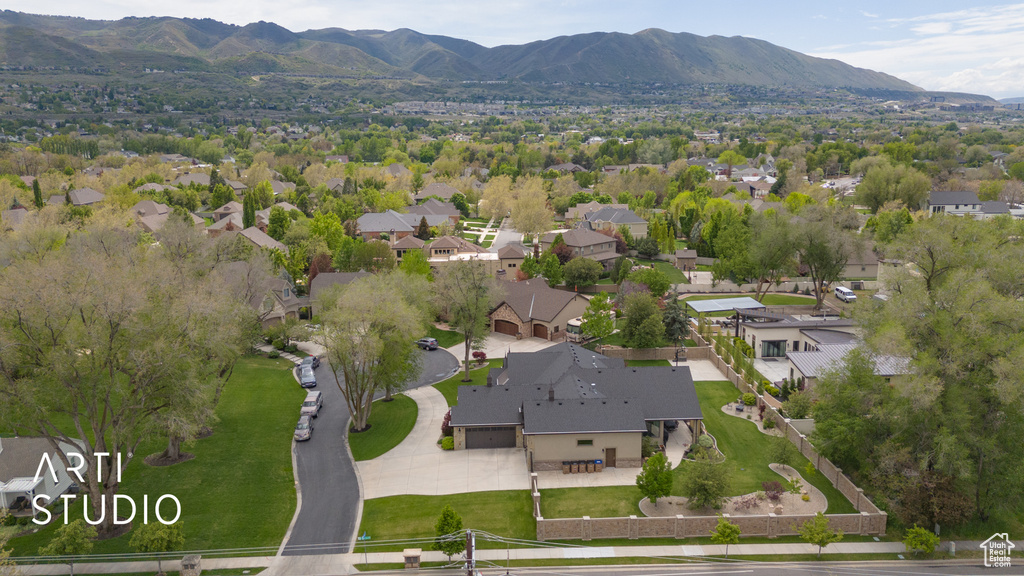 Aerial view of property's location featuring a mountainous background and nearby suburban area