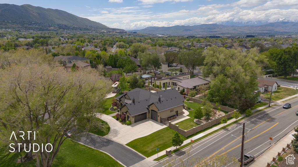 Aerial overview of property's location featuring a mountainous background and nearby suburban area