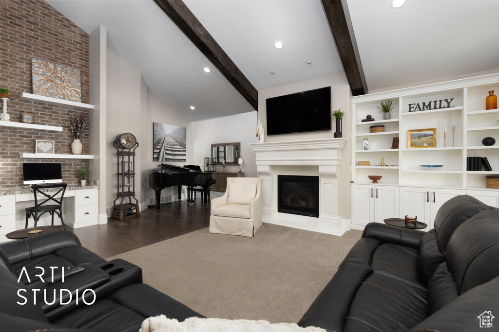 Living area with a glass covered fireplace, baseboards, and wood finished floors