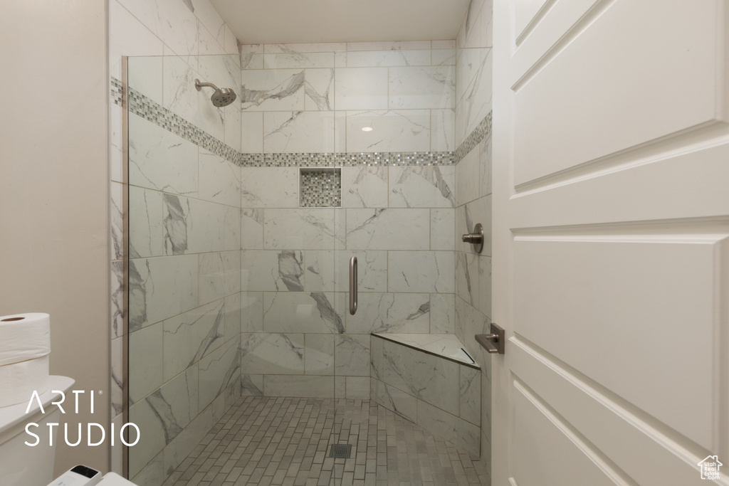 Full bathroom with a stall shower and toilet